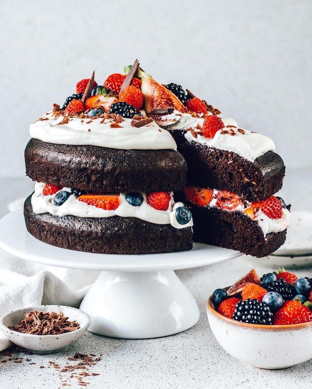 Decadent Layered Vegan Chocolate Cake with Whipped Cream and Fresh Berries