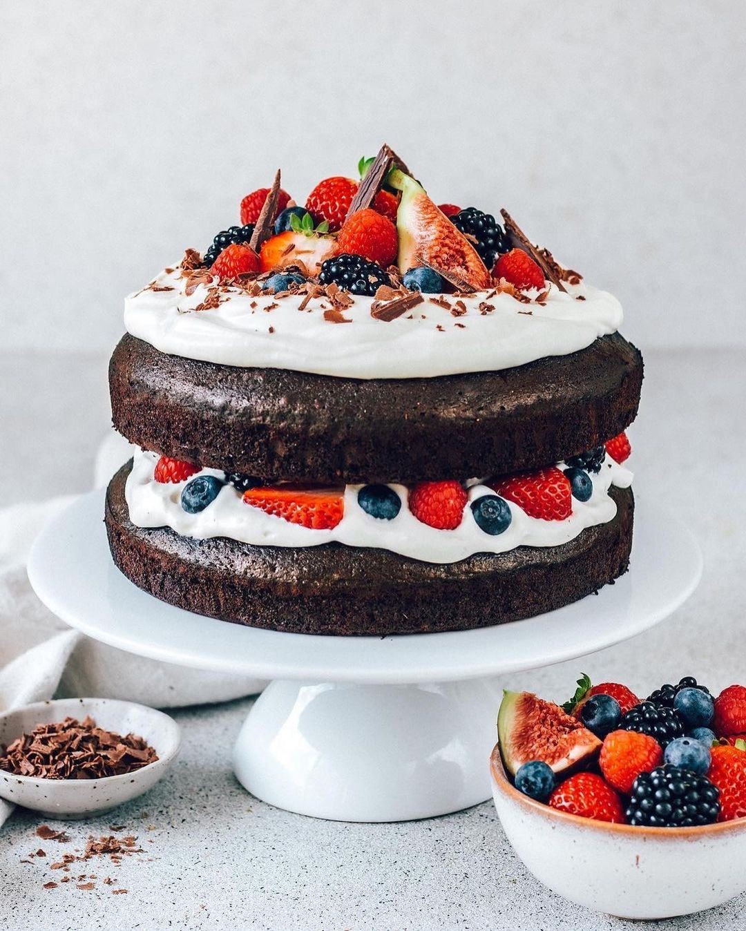 Decadent Layered Vegan Chocolate Cake with Whipped Cream and Fresh Berries