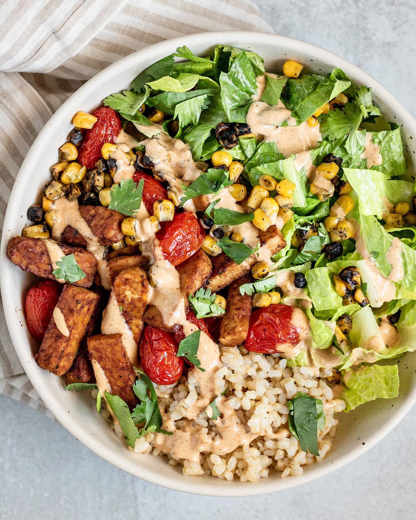 Tempeh and Tomato Nourish Bowl with Chipotle Lime Tahini Sauce