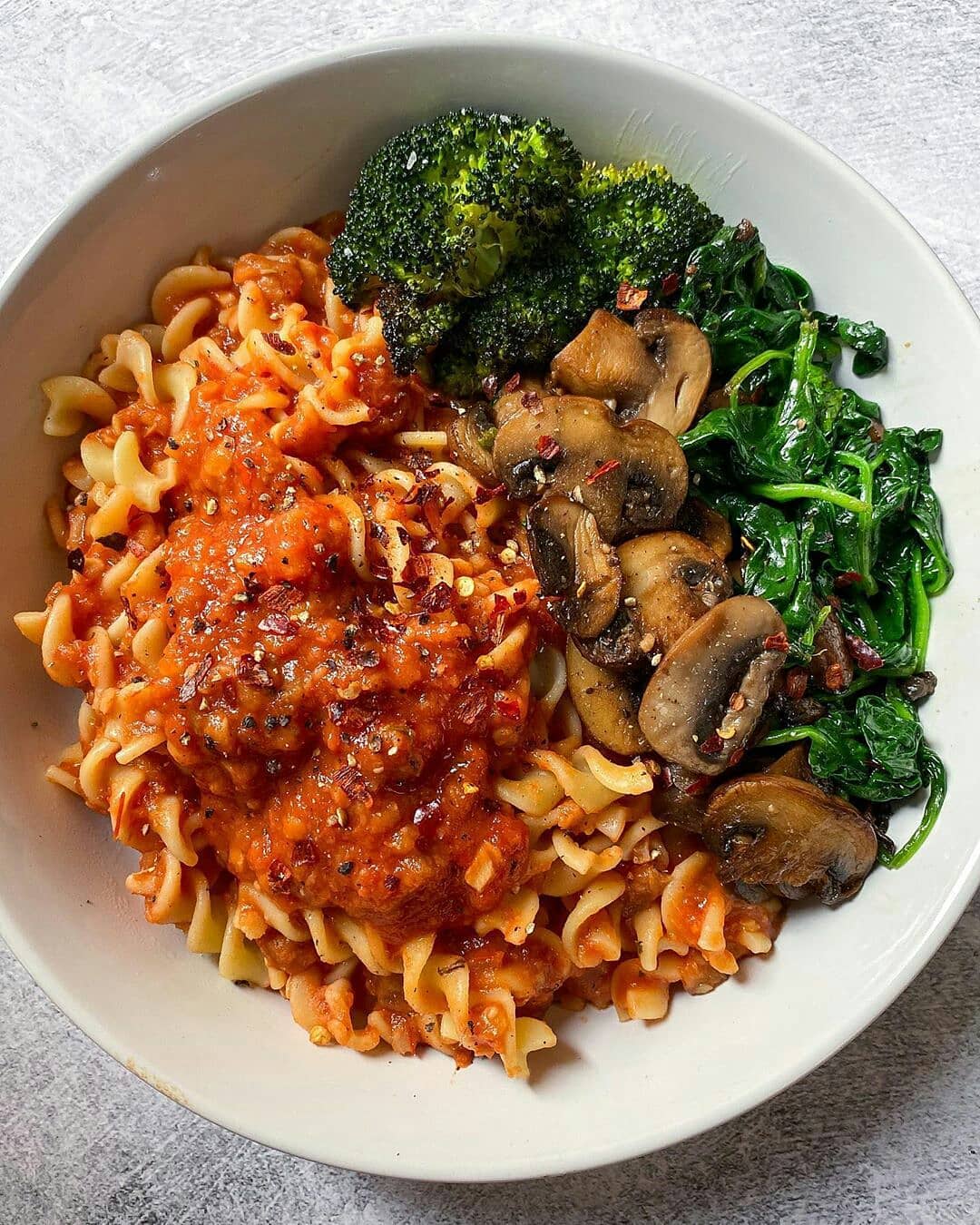 Red Lentil and Eggplant Bolognese with Fusilli, Roasted Broccoli, Garlicky Mushrooms and Spinach in Crushed Red Pepper Flakes