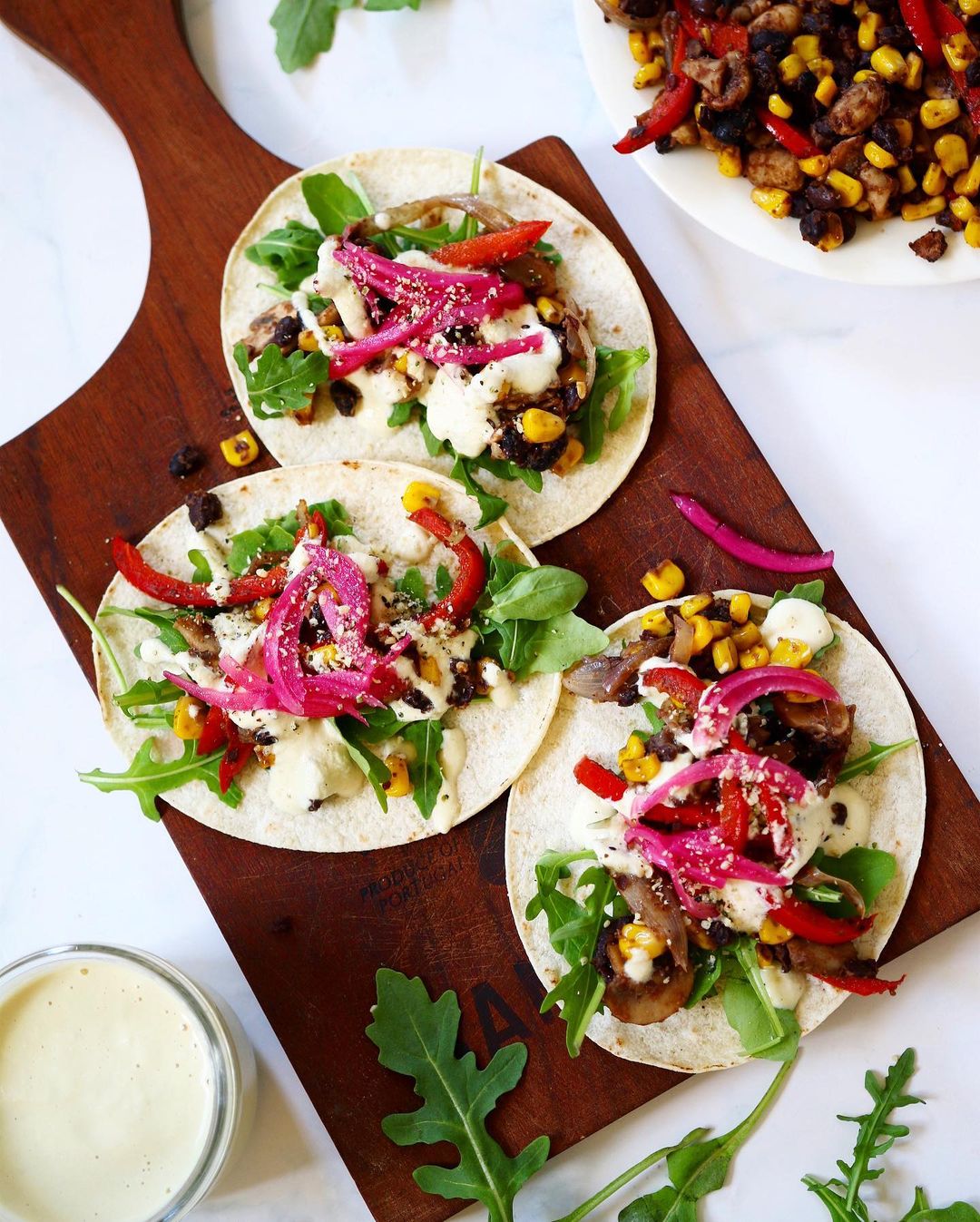 Bean Tacos with Arugula, Pickled Red Onion, Hemp Seeds and a Sour Cream Sauce