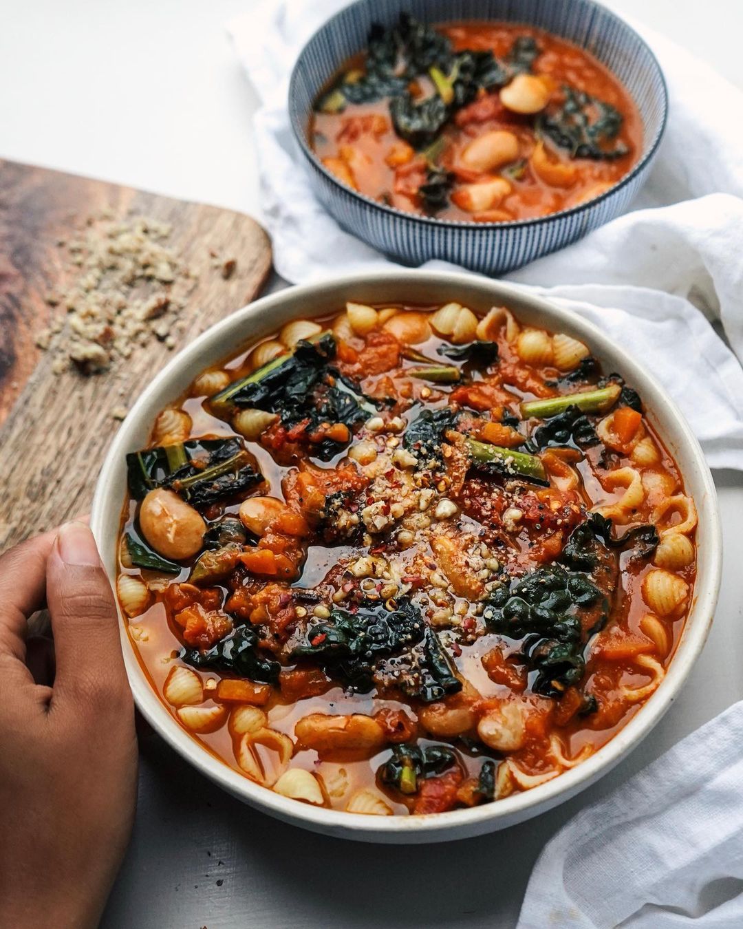 Butter Bean Kale Soup with a Likkle Pasta Topped with Chilli Flakes, Ground Macadamia Nuts, Salt, Black Pepper and Nutritional Yeast